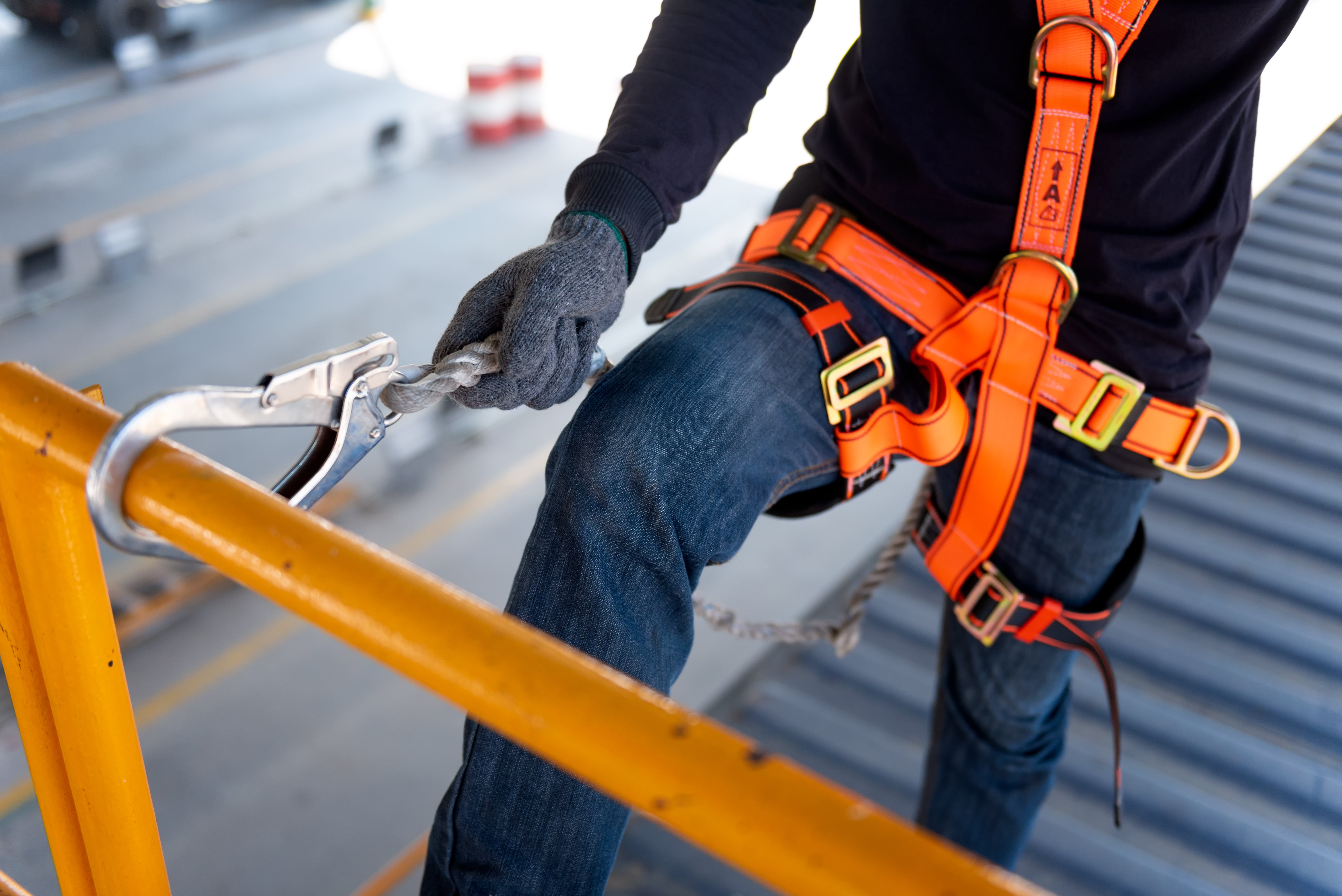 orig construction worker use safety harness and safety line shutterstock 1109366228